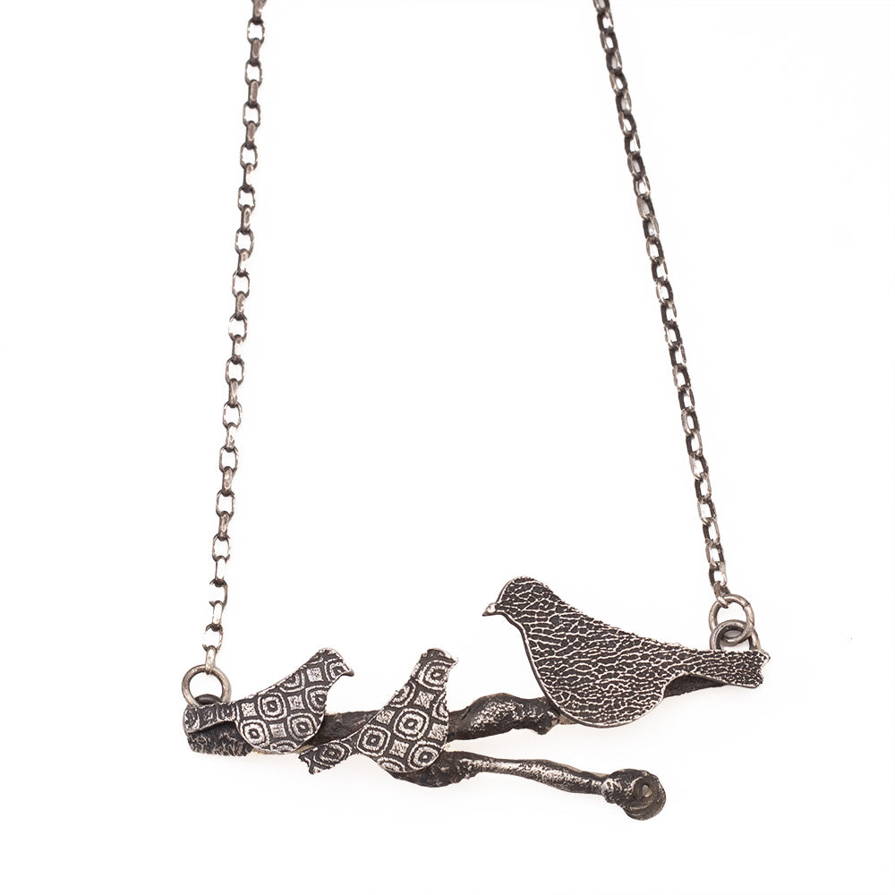 Sterling silver Storytime Necklace featuring three textured birds on a branch, artisan handmade nature-inspired jewelry.
