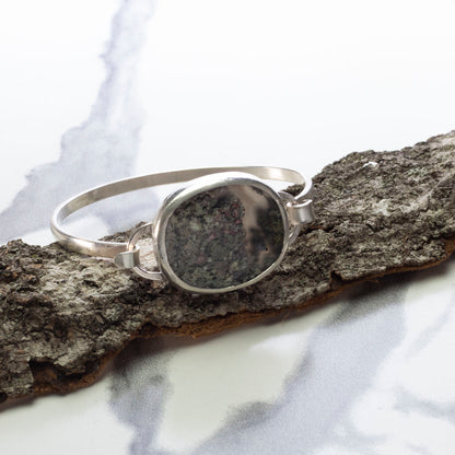 Sterling silver tension cuff with dendritic agate resembling a miniature landscape