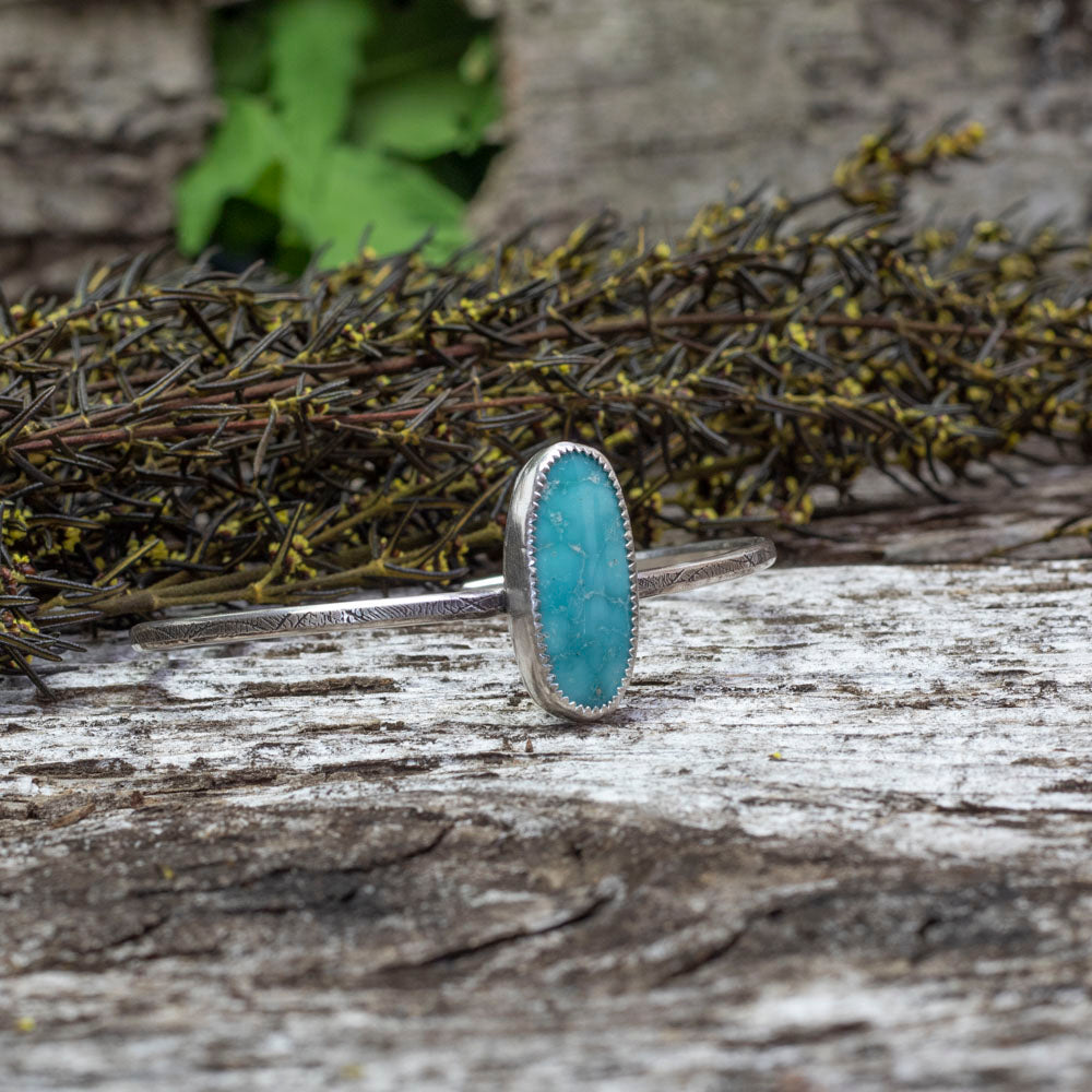 Sterling silver cuff bracelet with oval Whitewater turquoise stone and stamped band, handmade jewelry.