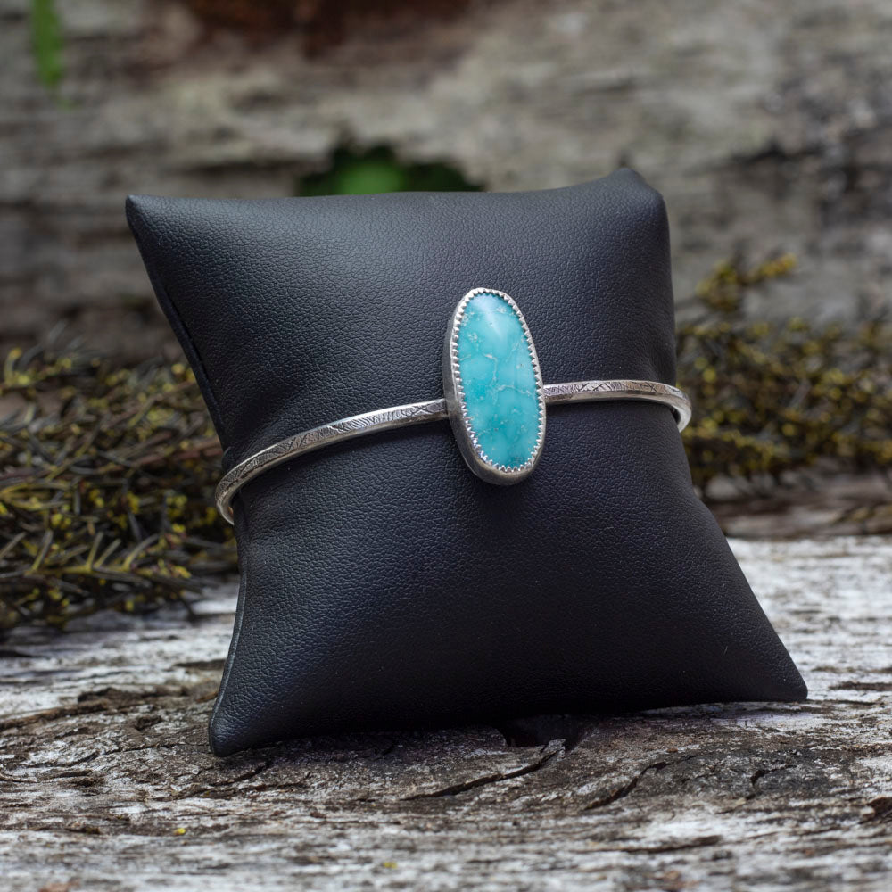 Sterling silver cuff bracelet with oval Whitewater turquoise stone and stamped band, handmade jewelry