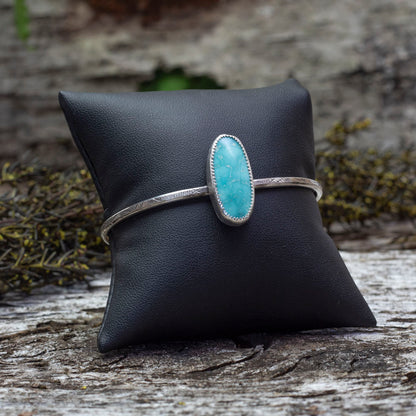 Sterling silver cuff bracelet with oval Whitewater turquoise stone and stamped band, handmade jewelry