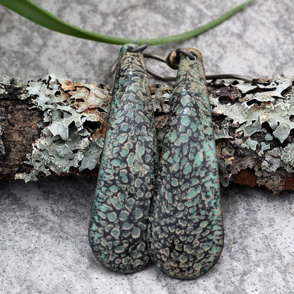 Long enamel earrings in green and black with lichen-like texture and niobium ear wires