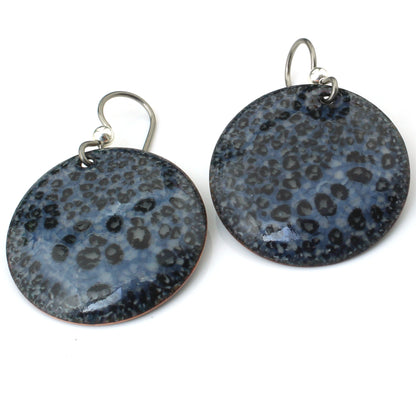 Round Black and gray boho earrings with an opalescent finish ona white background.