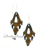 Pumpkin and yellow frond shaped enamel earrings on a white background by Divella Designs