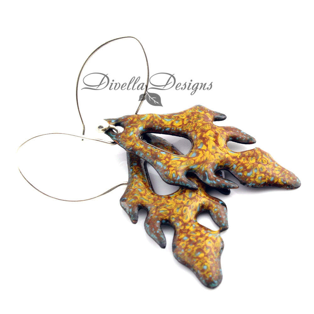 Pumpkin and yellow frond shaped enamel earrings on a white background by Divella Designs